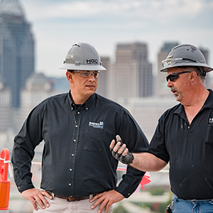 Two construction workers in conversation on job site