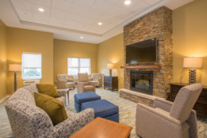Sheridan living space with fireplace and TV