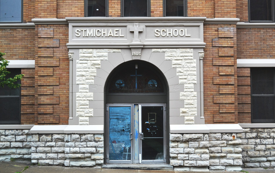 Exterior of school entrance, with stone framing.