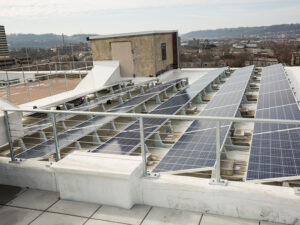 Rows of solar panels on the roof of a building in downtown Cincinnati.