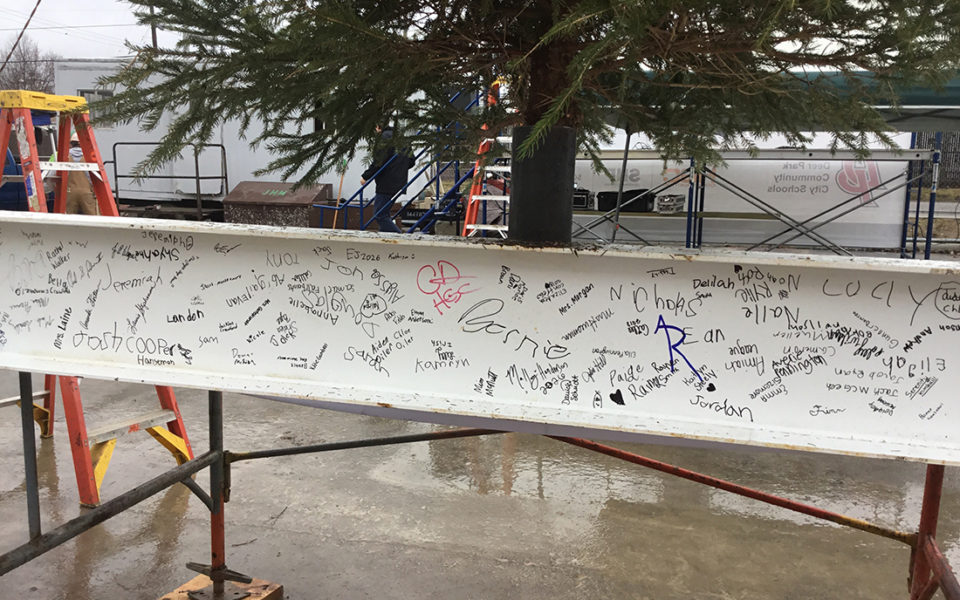 A steel beam covered in signatures of the Deer Park community. Some signatures are neatly penned adult signatures, while others are the enthusiastic scrawls of young children. Part of the 