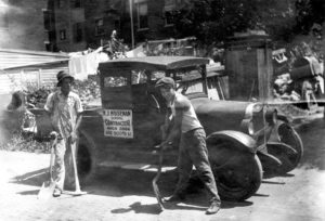 old photo of founder of HGC Construction in front of their first truck