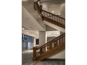 Large wooden staircase near entrance of hotel.