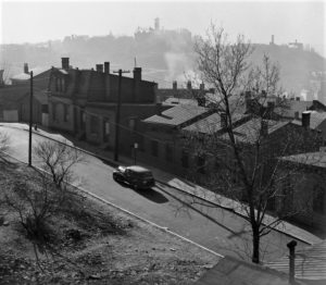 Residential houses and a car parked out front during the 1940s in cincinnati