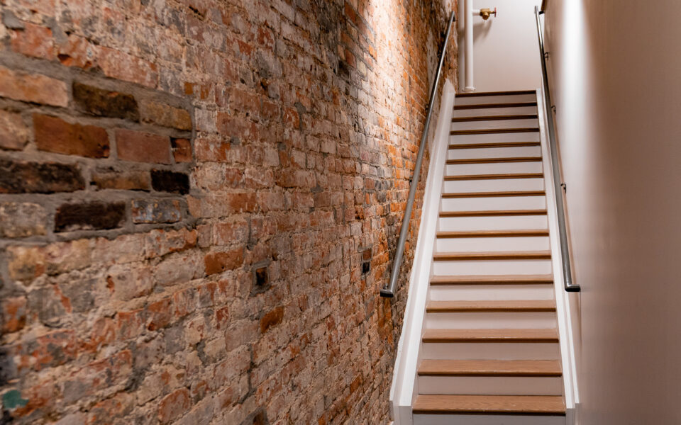 Interior stairs and exposed brick wall