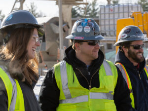 smiling project managers on job site enjoying construction careers, jobs in construction