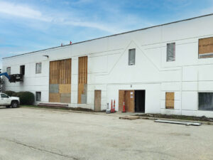 exterior of Stagnaro warehouse with new openings cut in for windows